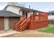 Backyard featuring a wooden deck with stairs and railing, accessible through a sliding glass door at 9380 Raleigh Ct, Westminster, CO 80031