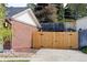 Backyard access gate leads to parking area adjacent to brick garage at 9380 Raleigh Ct, Westminster, CO 80031