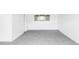 Finished basement features neutral carpet, white walls, window and a white door at 9380 Raleigh Ct, Westminster, CO 80031