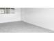 Finished basement features neutral carpet, white walls, window and a white door at 9380 Raleigh Ct, Westminster, CO 80031