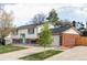 Charming two-story home with a brick facade, attached two car garage, and green lawn at 9380 Raleigh Ct, Westminster, CO 80031