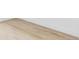 Close up of laminate flooring with white base trim and painted white walls at 9380 Raleigh Ct, Westminster, CO 80031