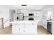 Bright, updated kitchen featuring white cabinetry, stainless steel appliances and an island at 9380 Raleigh Ct, Westminster, CO 80031