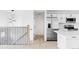 Modern kitchen with stainless steel appliances, white cabinetry, and a quartz countertop island at 9380 Raleigh Ct, Westminster, CO 80031