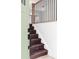 View of the wooden staircase with metal balusters from the entry featuring a wooden railing at 9380 Raleigh Ct, Westminster, CO 80031