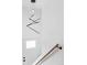 Modern light fixture, stair railing, and stairway door at 9380 Raleigh Ct, Westminster, CO 80031