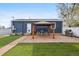 Cozy backyard featuring a brick patio with pergola, seating, grill, lush green lawn, and partial fencing at 1498 S Perry St, Denver, CO 80219