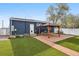 The backyard features a covered patio, grill, turf, and partial fencing, perfect for outdoor relaxation and entertaining at 1498 S Perry St, Denver, CO 80219