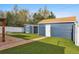 This backyard features a well-maintained lawn and two storage sheds, perfect for your outdoor needs at 1498 S Perry St, Denver, CO 80219