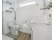 Modern bathroom featuring a glass-enclosed shower, floating shelves, an integrated sink, and contemporary finishes for a spa-like feel at 1498 S Perry St, Denver, CO 80219