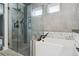 Bathroom with walk-in shower, soaking tub and black fixtures at 1498 S Perry St, Denver, CO 80219