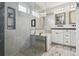 Bathroom featuring a walk-in shower, soaking tub and double vanity at 1498 S Perry St, Denver, CO 80219