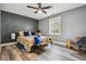 Bright bedroom featuring a ceiling fan, grey walls and a large window at 1498 S Perry St, Denver, CO 80219