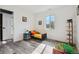 Bright bedroom with a window, grey floors and white walls at 1498 S Perry St, Denver, CO 80219