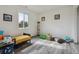 Bright bedroom featuring a large window and grey floors at 1498 S Perry St, Denver, CO 80219