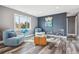 Cozy living room featuring modern decor, comfortable seating, hardwood floors and a window that provides natural light at 1498 S Perry St, Denver, CO 80219