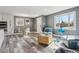 Bright living room with stylish gray walls, modern flooring, comfortable seating, and ample natural light from large windows at 1498 S Perry St, Denver, CO 80219