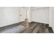 Empty room with luxury vinyl plank flooring and open door to bathroom in back at 1498 S Perry St, Denver, CO 80219