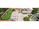 Aerial view featuring a custom home, putting green, and manicured landscaping at 3299 S Newcombe St, Lakewood, CO 80227