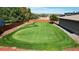 Private backyard putting green with multiple holes, perfect for golf enthusiasts and outdoor recreation at 3299 S Newcombe St, Lakewood, CO 80227