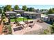 Landscaped backyard features a well-manicured lawn, pergola, a fire pit, and an outdoor seating area at 3299 S Newcombe St, Lakewood, CO 80227