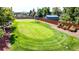 This backyard has its own putting green in addition to planter boxes for gardening at 3299 S Newcombe St, Lakewood, CO 80227