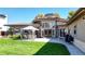 Expansive backyard with well-manicured lawn, mature trees, and a charming patio area for outdoor entertaining at 3299 S Newcombe St, Lakewood, CO 80227