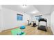 Basement gym with an elliptical, stationary bike, treadmill, and wood-look flooring at 3299 S Newcombe St, Lakewood, CO 80227