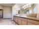 Primary bathroom featuring a double sink vanity, large mirror and tile flooring at 3299 S Newcombe St, Lakewood, CO 80227