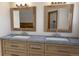 Bathroom featuring double sinks, wooden cabinets and modern hardware at 3299 S Newcombe St, Lakewood, CO 80227