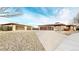 Expansive home featuring a long driveway leading to multiple garages, set against a blue sky at 3299 S Newcombe St, Lakewood, CO 80227