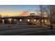 Exterior shot of house at dusk, with a terracotta roof and three-car garage at 3299 S Newcombe St, Lakewood, CO 80227