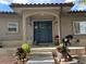 Charming front porch with a blue front door, seating, and decorative plants at 3299 S Newcombe St, Lakewood, CO 80227