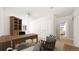 Bright home office with custom shelving, storage, a large wooden desk, and a comfortable seating area at 3299 S Newcombe St, Lakewood, CO 80227