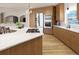 Modern kitchen features stainless steel appliances, beautiful cabinets, an island with seating, and updated countertops at 3299 S Newcombe St, Lakewood, CO 80227
