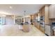 Spacious kitchen with updated appliances and cabinetry plus a rounded center island and granite countertops at 3299 S Newcombe St, Lakewood, CO 80227