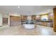 Spacious kitchen featuring custom cabinets, updated stainless steel appliances, and a large island at 3299 S Newcombe St, Lakewood, CO 80227