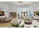 Bright living room with vaulted ceilings, large windows, wood floors, and an open dining area at 3299 S Newcombe St, Lakewood, CO 80227