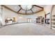 Spacious living room featuring large windows, fireplace, and custom built-in shelving at 3299 S Newcombe St, Lakewood, CO 80227