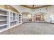 Open-concept living room with custom shelving and easy access to entry at 3299 S Newcombe St, Lakewood, CO 80227