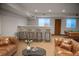Inviting living room with bar, leather seating, and a billiard table for a fun and relaxing atmosphere at 3299 S Newcombe St, Lakewood, CO 80227
