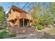 Exterior view of home featuring a brick patio and beautiful landscaping at 9400 E Iliff Ave # 181, Denver, CO 80231