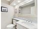 Bathroom featuring tiled backsplash, large mirror, white cabinetry, and toilet at 9400 E Iliff Ave # 181, Denver, CO 80231