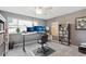 Bedroom with large windows, ceiling fan, desk with monitors and gray walls at 9400 E Iliff Ave # 181, Denver, CO 80231