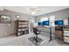 Bedroom with gray carpet, ceiling fan, desk with monitors, and shelving units at 9400 E Iliff Ave # 181, Denver, CO 80231