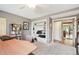 Bedroom with gray carpet, desk with monitors, bookshelf, attached closet and entry at 9400 E Iliff Ave # 181, Denver, CO 80231
