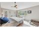 Sunlit bedroom with large window, ceiling fan, and neutral décor at 9400 E Iliff Ave # 181, Denver, CO 80231