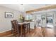 Sunlit dining area boasts hardwood floors and an open floor plan to the entry and kitchen at 9400 E Iliff Ave # 181, Denver, CO 80231