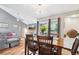 Cozy dining area boasts hardwood floors, modern light fixture and natural light at 9400 E Iliff Ave # 181, Denver, CO 80231