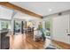 The dining area features hardwood floors, a wooden beam and glass doors to the backyard at 9400 E Iliff Ave # 181, Denver, CO 80231